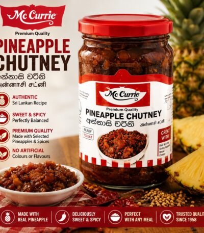 A glass jar of Mc Currie Pineapple Chutney with fresh pineapple, dried chilies, and a small bowl of chunky chutney.