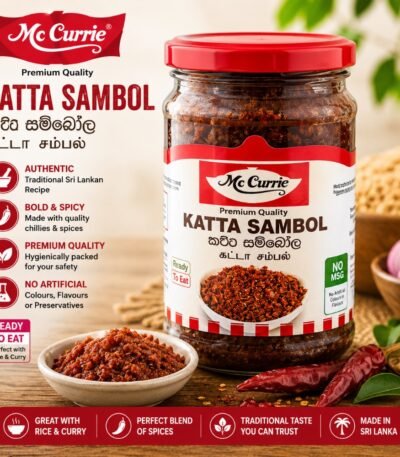 A glass jar of Mc Currie Katta Sambol next to a bowl of sambol and red chillies on a wooden table.